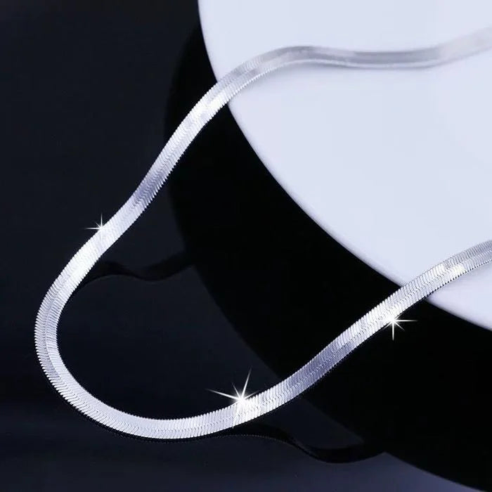 This 925 Sterling silver 18K Gold 4MM Flat chain Necklace for Women is a stunning piece of jewelry that combines elegance and sophistication. Crafted with precision, this necklace exudes luxury and style, making it a versatile accessory for any occasion. Its unique design and high-quality materials ensure a timeless look that will elevate your outfit effortlessly.