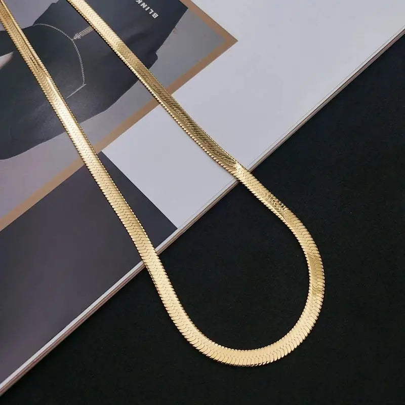 This 925 Sterling silver 18K Gold 4MM Flat chain Necklace for Women is a stunning piece of jewelry that combines elegance and sophistication. Crafted with precision, this necklace exudes luxury and style, making it a versatile accessory for any occasion. Its unique design and high-quality materials ensure a timeless look that will elevate your outfit effortlessly.