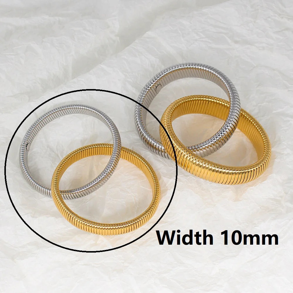 The image depicts a stylish bracelet with a ribbed design in a shiny rose gold color, suggesting it is made of 18k gold plated titanium. The bracelet features a twisted, interwoven appearance, giving it a unique and fashionable look. It appears to be a single, continuous band without clasps, showcasing its design.
