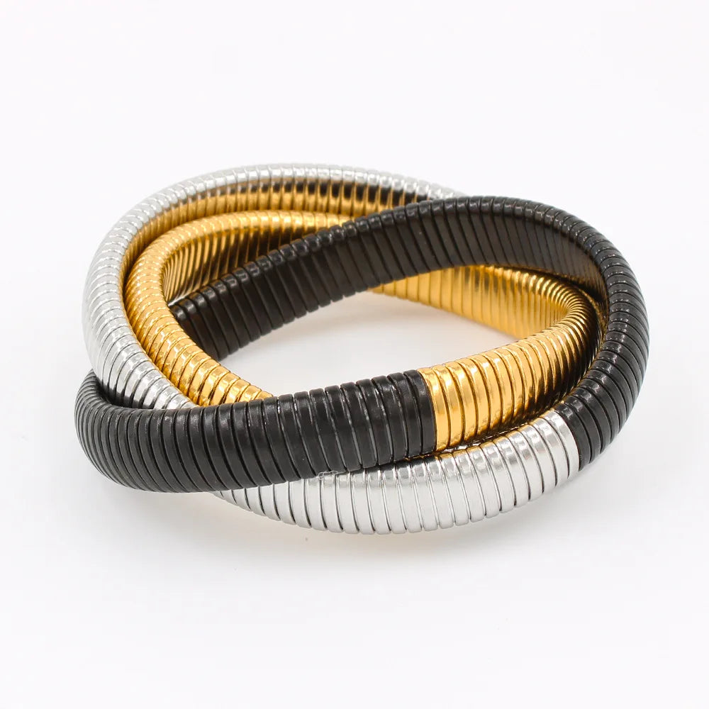 The image depicts a stylish bracelet with a ribbed design in a shiny rose gold color, suggesting it is made of 18k gold plated titanium. The bracelet features a twisted, interwoven appearance, giving it a unique and fashionable look. It appears to be a single, continuous band without clasps, showcasing its design.