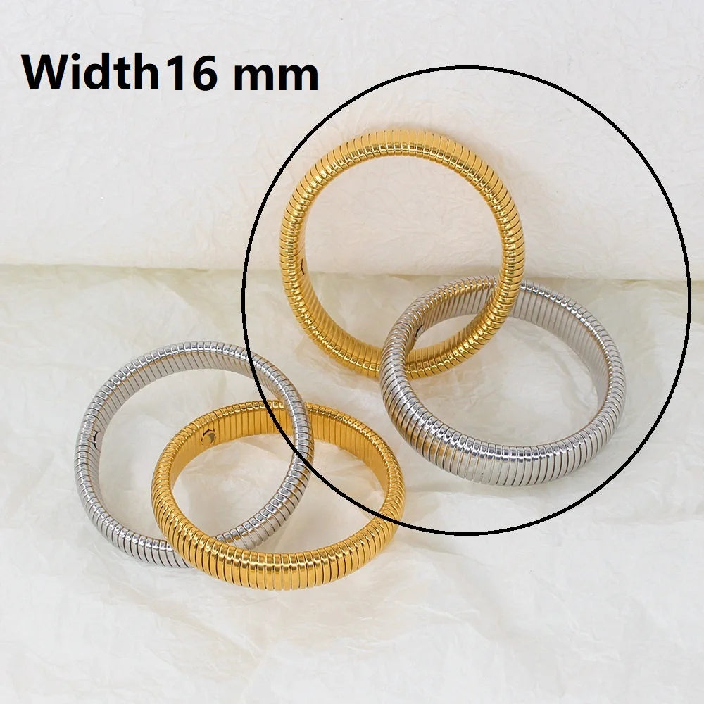 The image depicts a stylish bracelet with a ribbed design in a shiny rose gold color, suggesting it is made of 18k gold plated titanium. The bracelet features a twisted, interwoven appearance, giving it a unique and fashionable look. It appears to be a single, continuous band without clasps, showcasing its design.