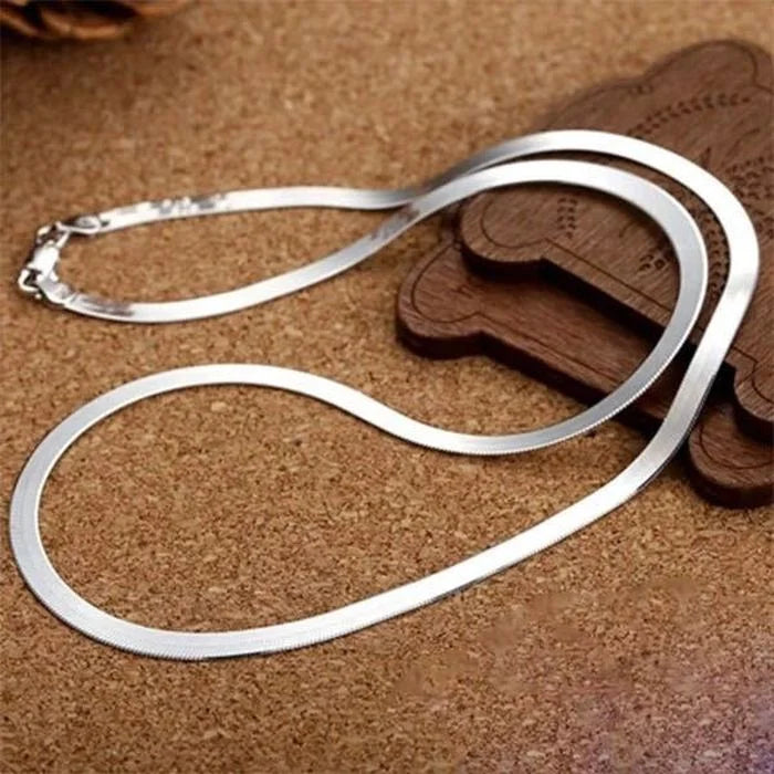 This 925 Sterling silver 18K Gold 4MM Flat chain Necklace for Women is a stunning piece of jewelry that combines elegance and sophistication. Crafted with precision, this necklace exudes luxury and style, making it a versatile accessory for any occasion. Its unique design and high-quality materials ensure a timeless look that will elevate your outfit effortlessly.